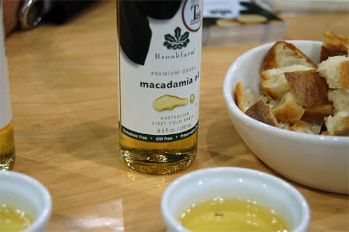 Cold-pressed macadamia oil with bowls and bottles